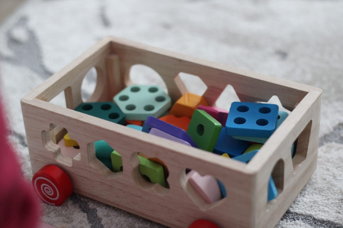 A preschool child playing with shape sorting toys