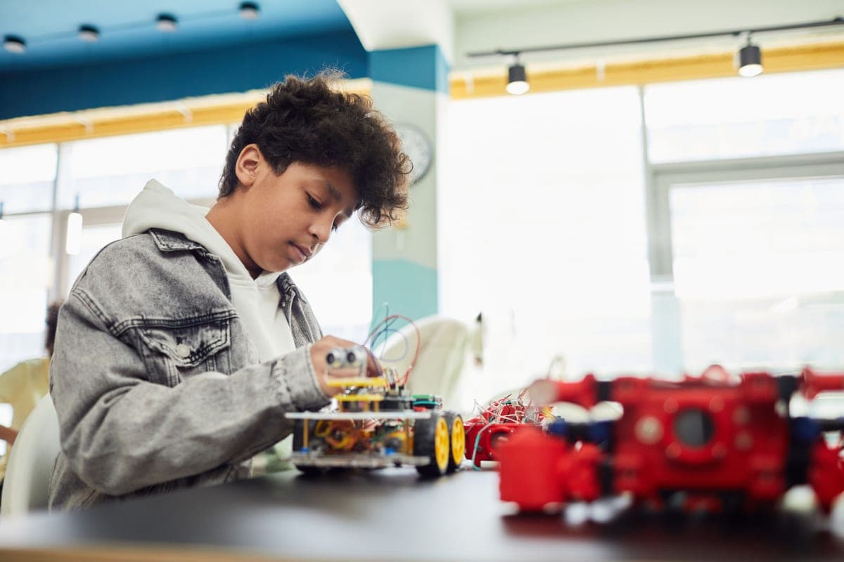 A child assembling a toy robot at a table