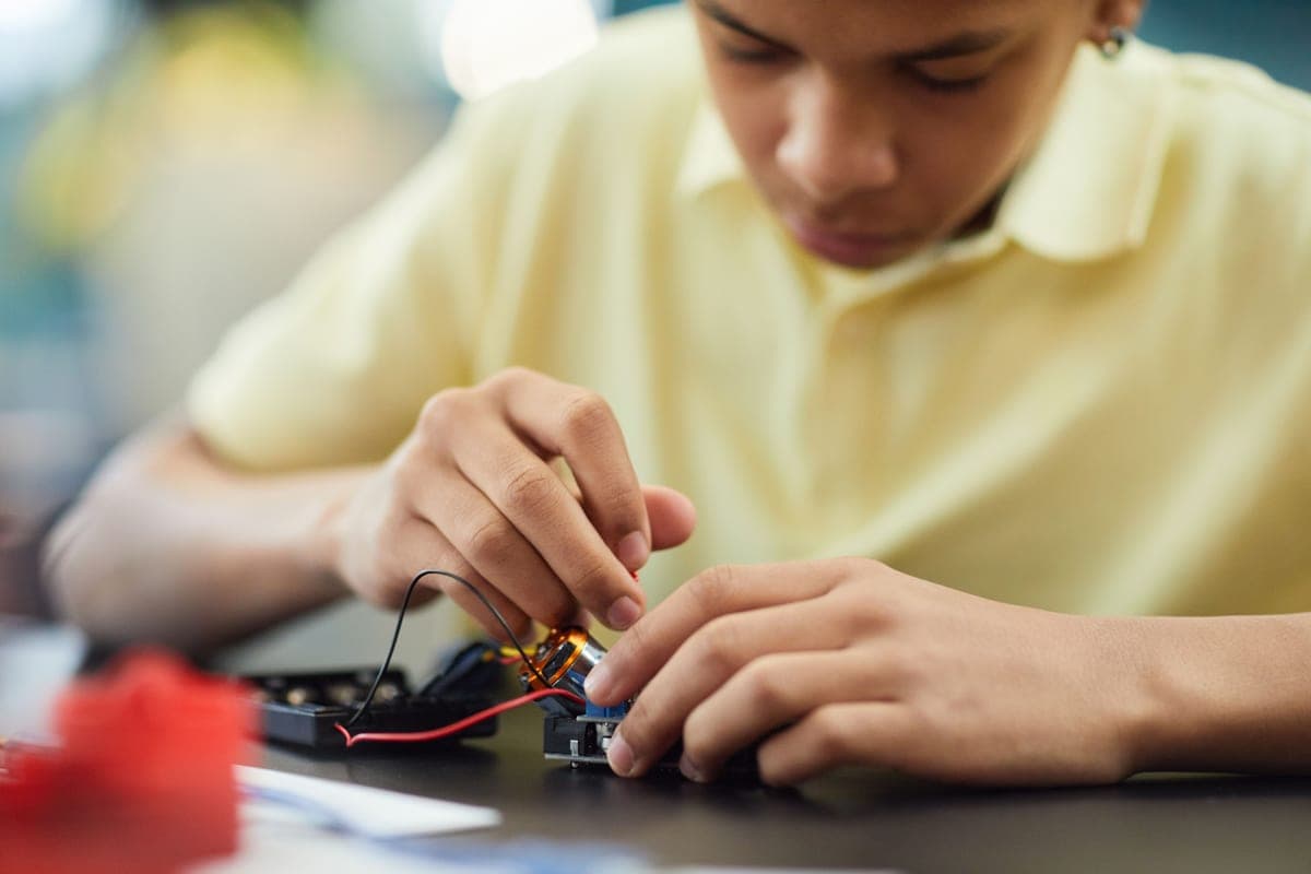 A teenager working on a robotics project