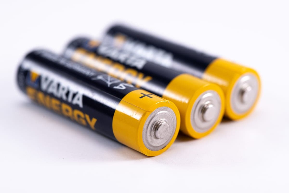 Assorted batteries laid out on a light surface