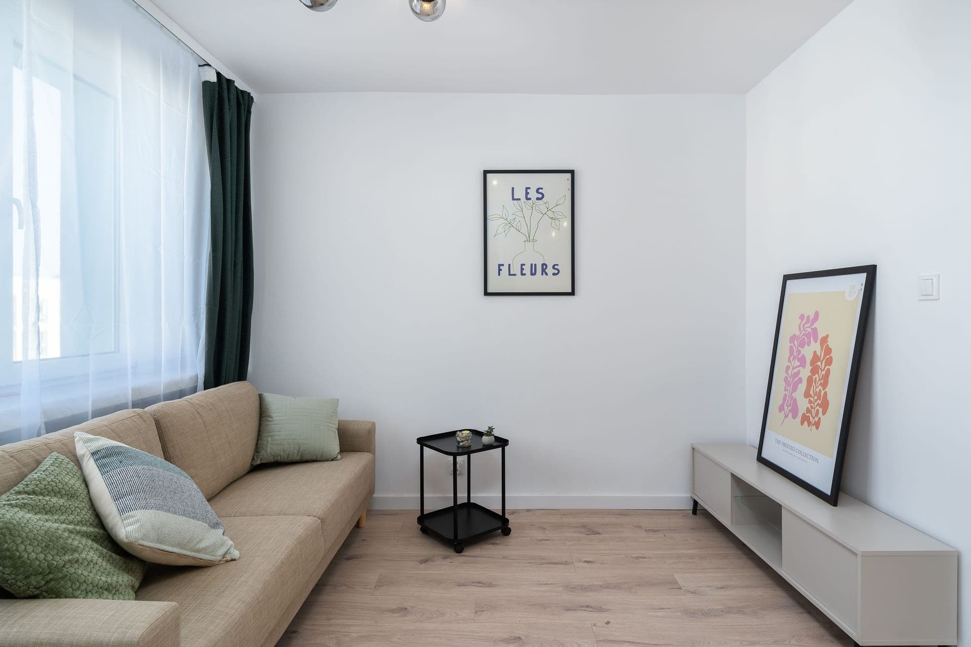 A tidy small living room with toys stored neatly