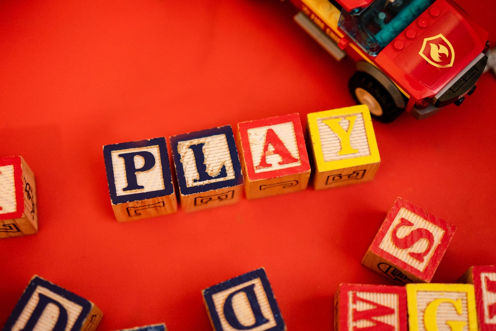 A toy car built from colorful building tiles