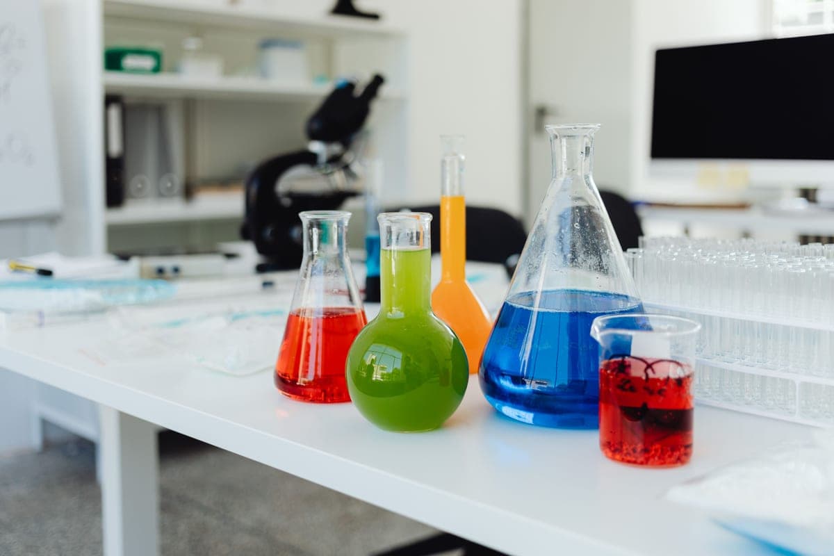 Test tubes containing colorful liquids on a bench