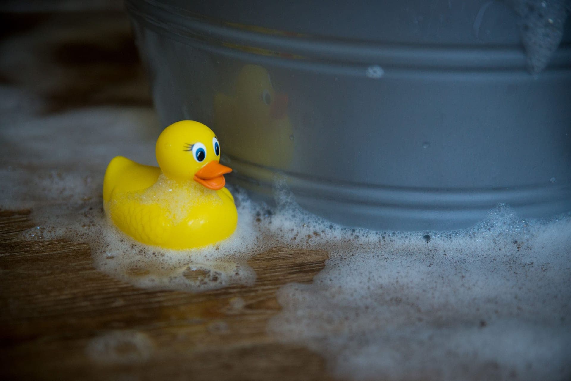 Plastic toys being washed in soapy water