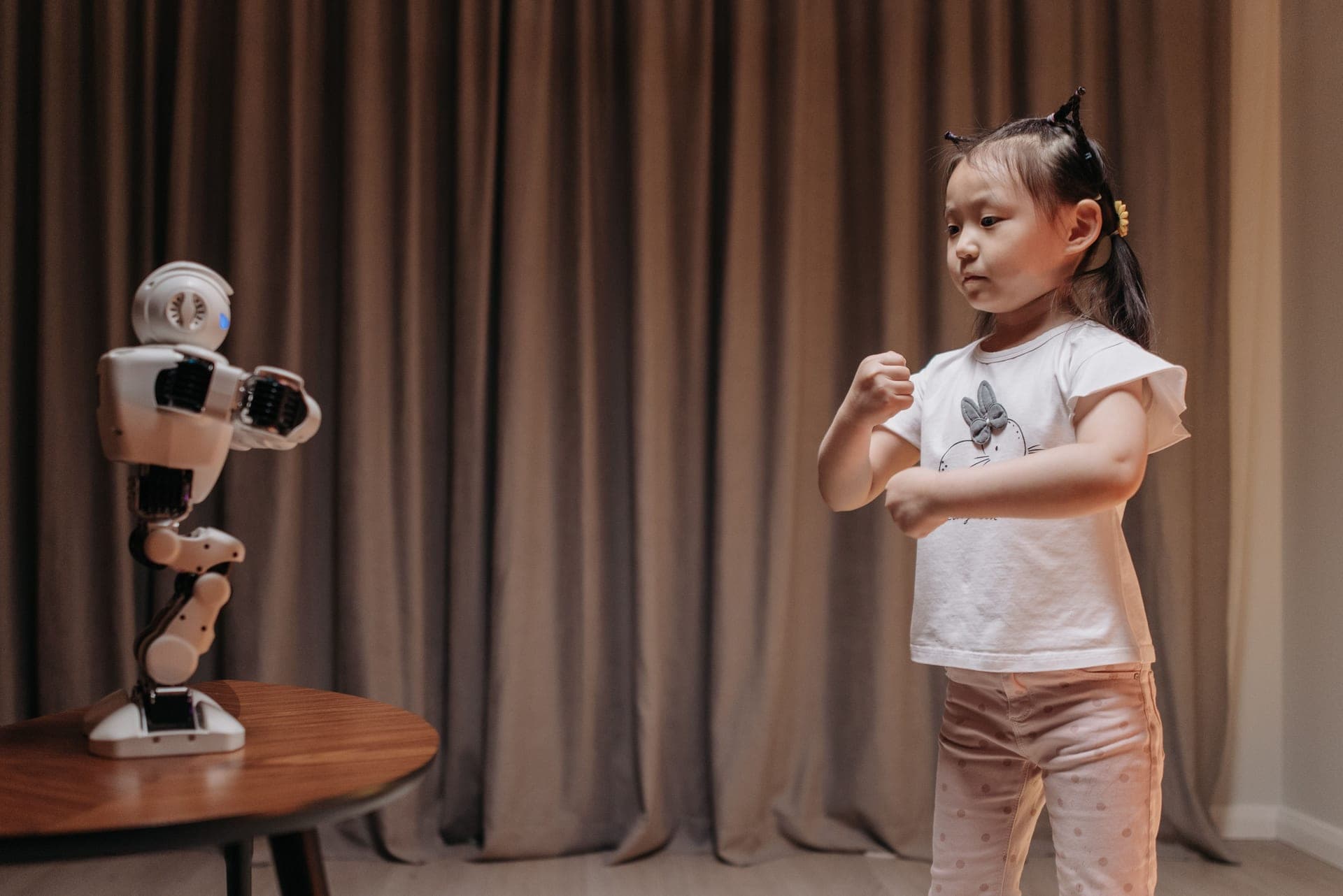 A young child playing with a simple robot toy