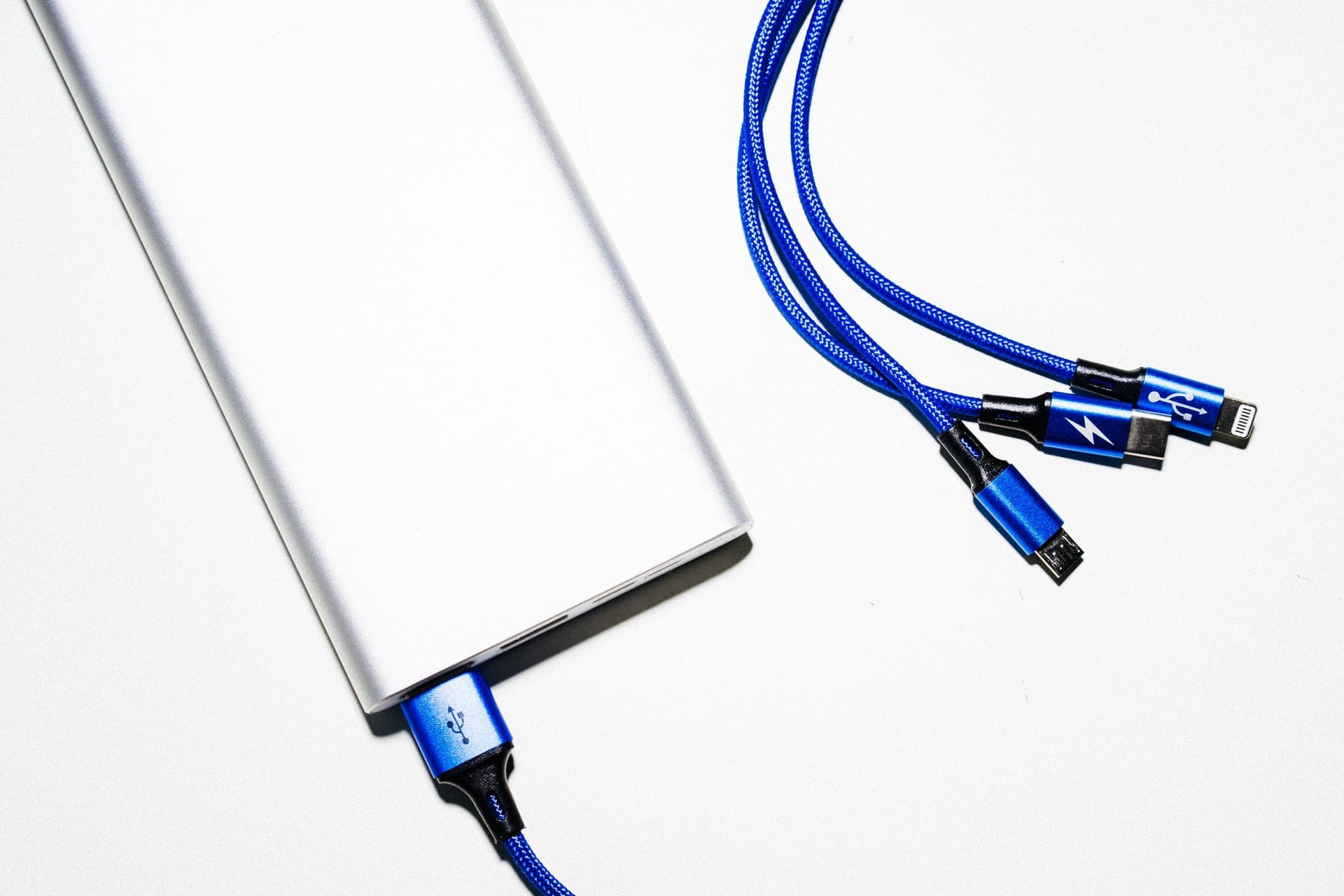 A USB cable charging a small device