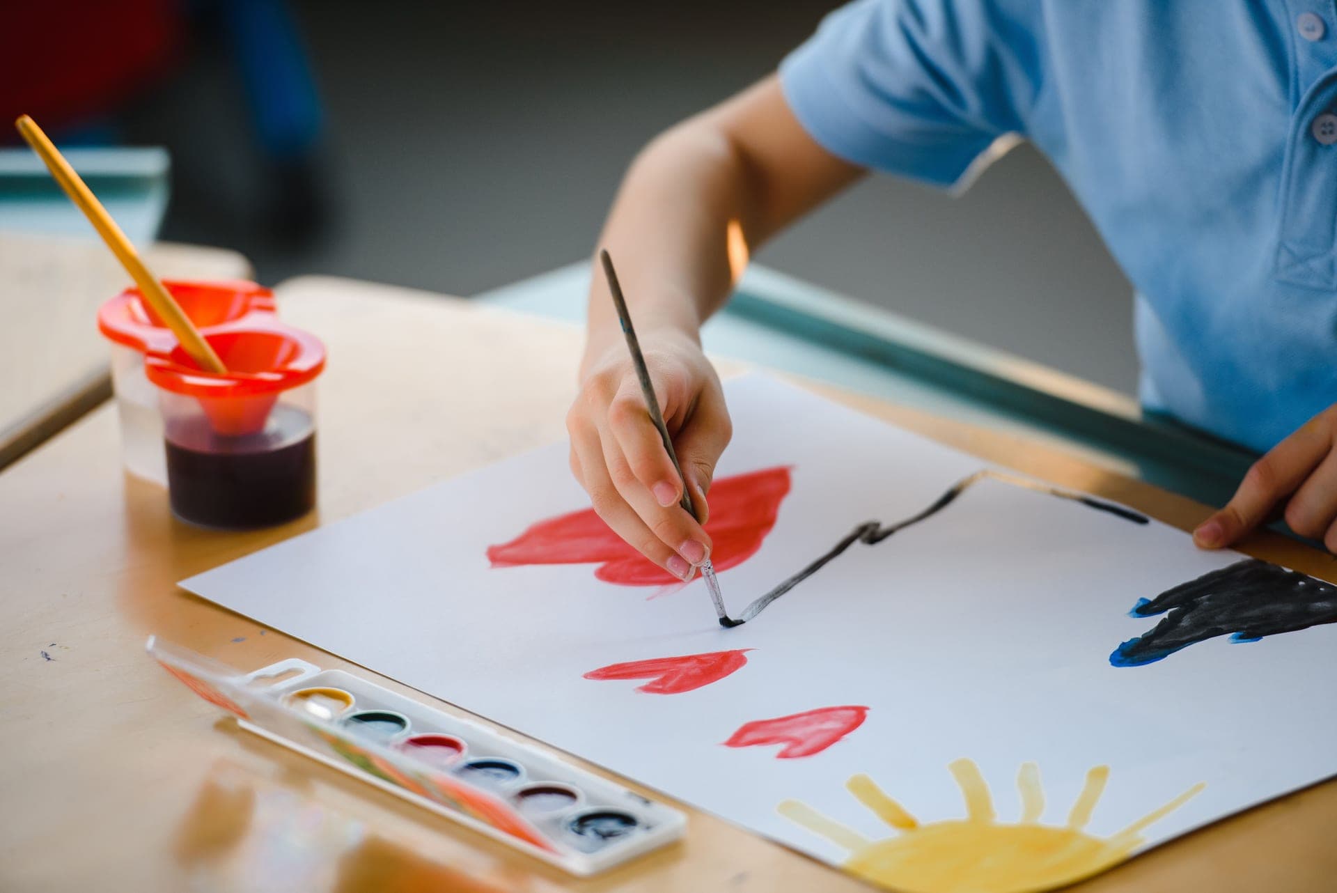 A young child painting with watercolors