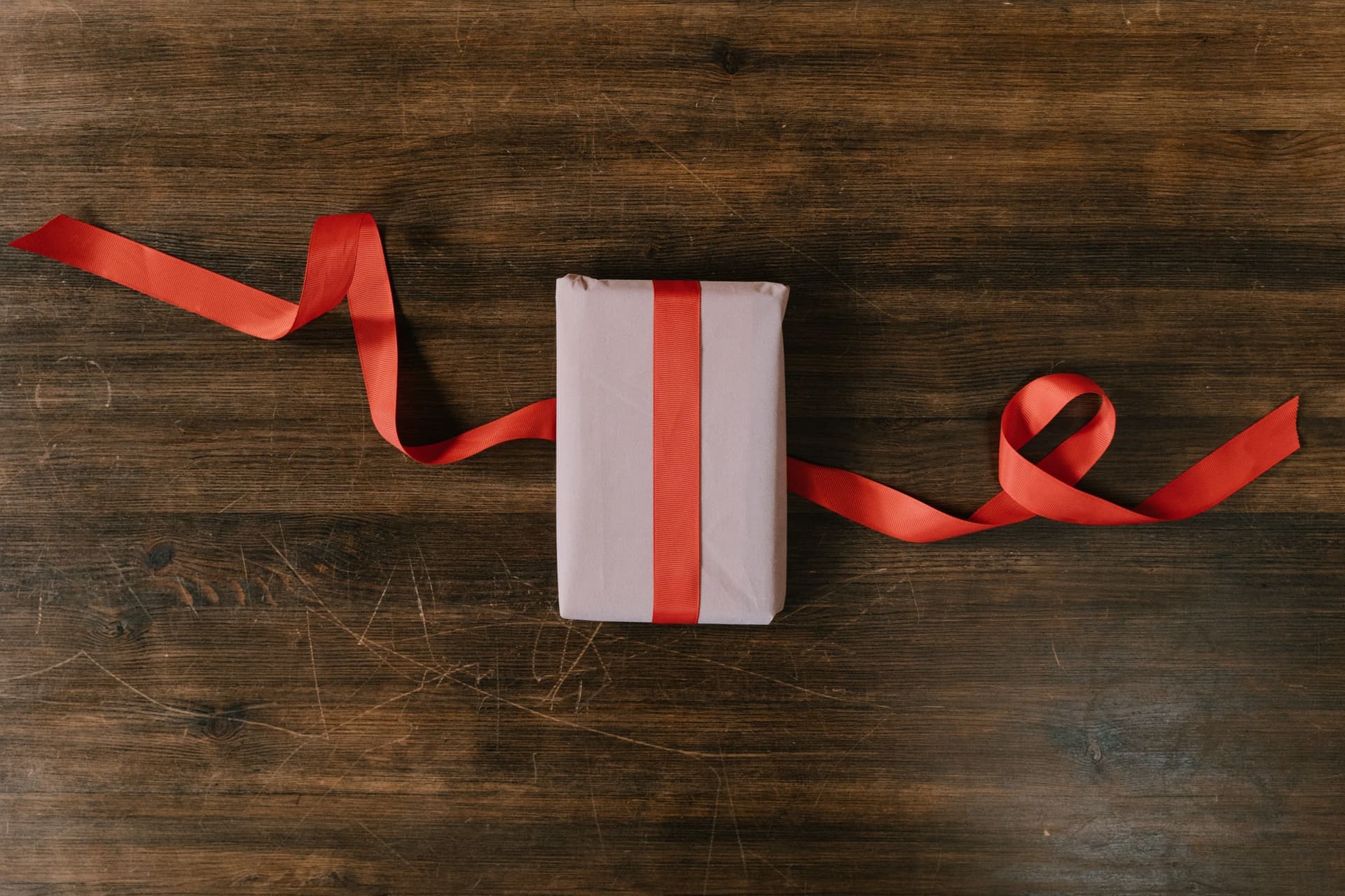 A wrapped gift with a ribbon on a table