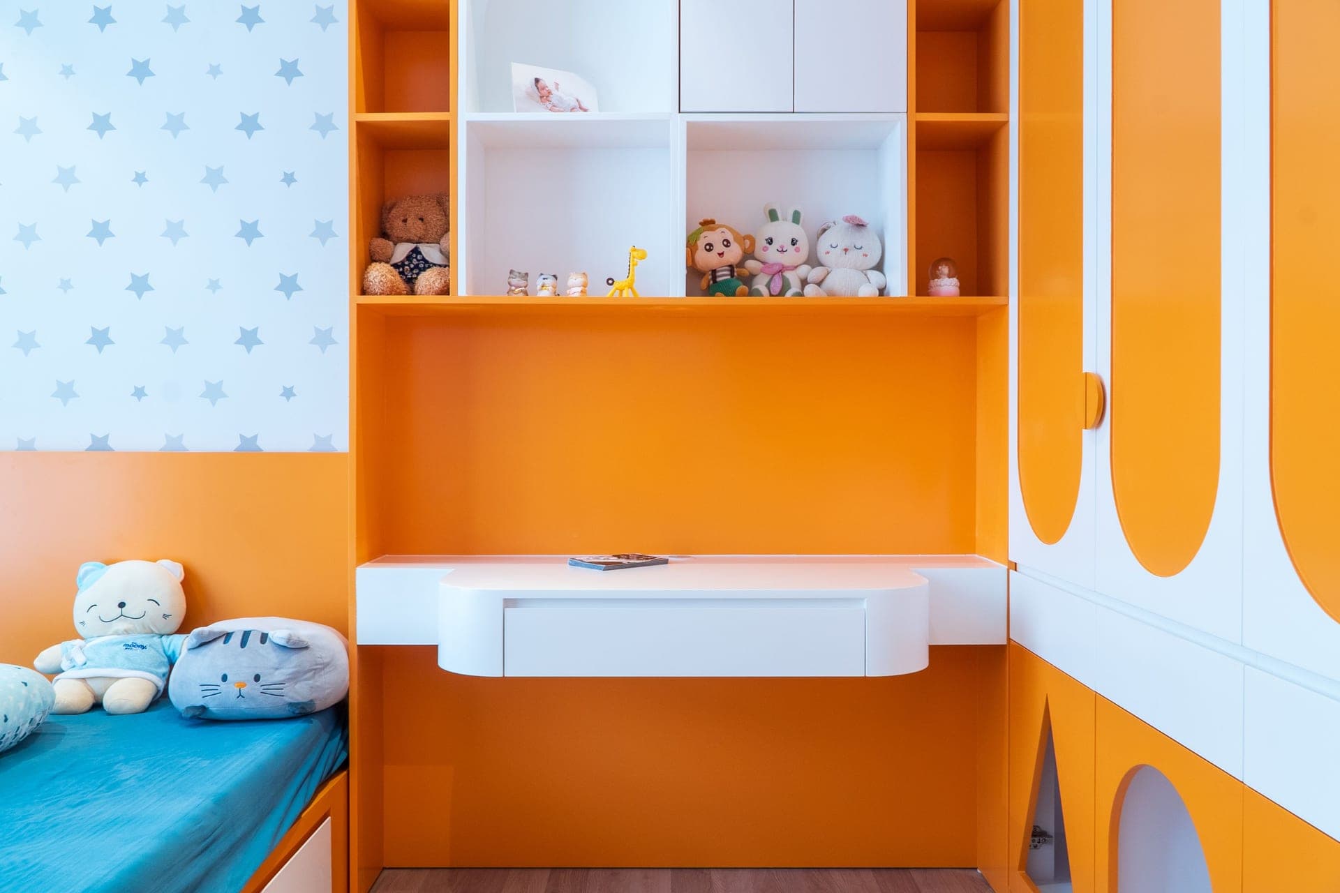 An overflowing toy shelf in a bedroom