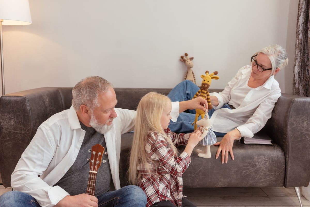 A grandparent and grandchild playing together with toys