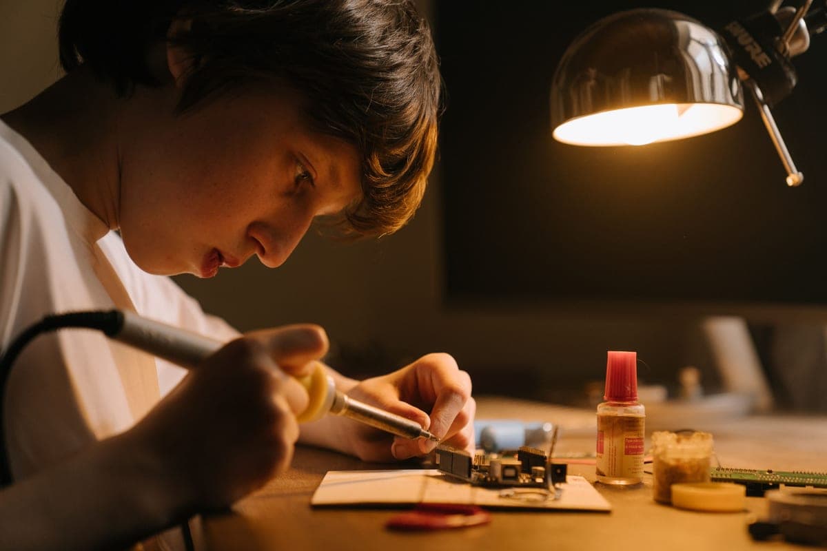 A teenager working on an electronics project