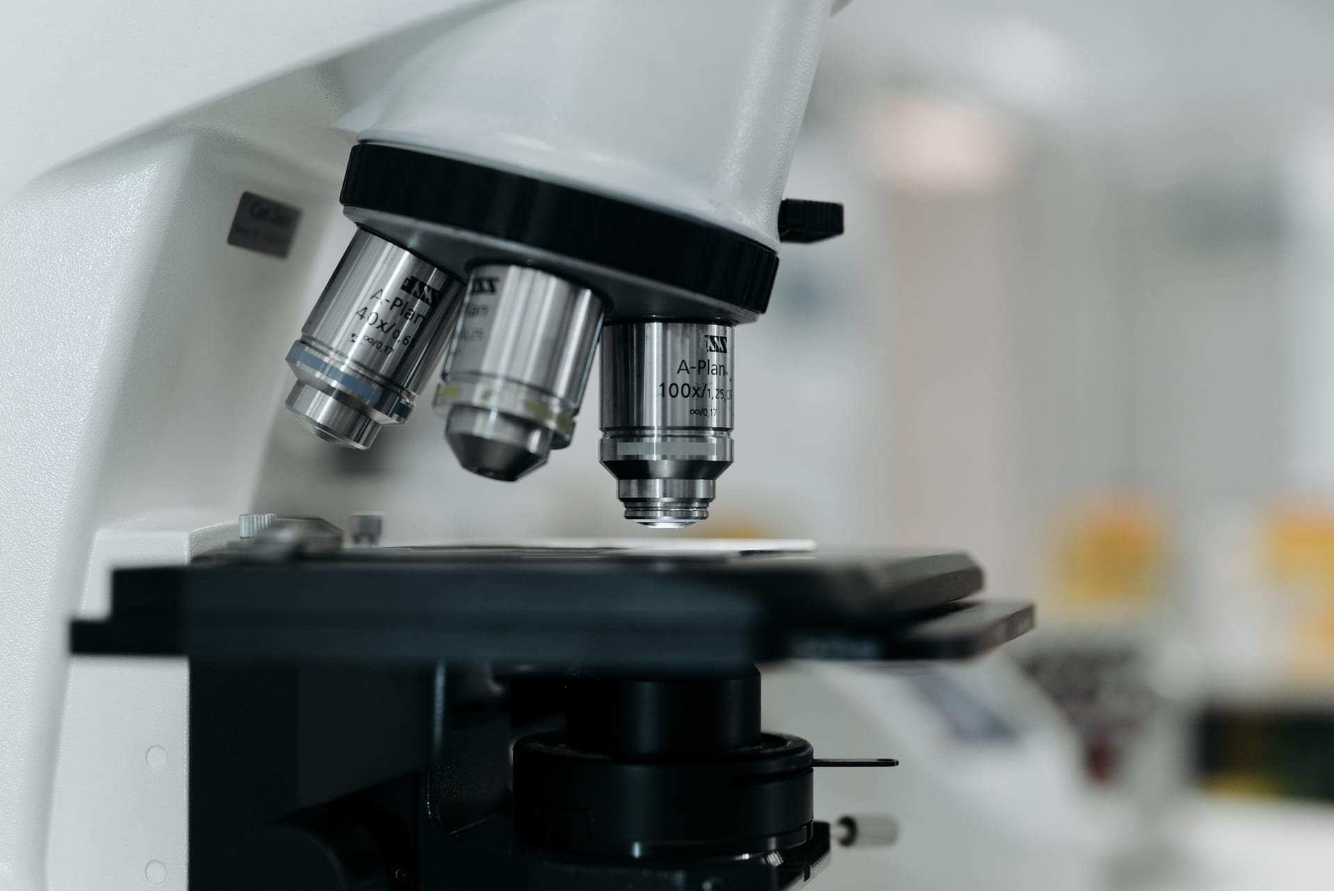 A microscope and magnifying tools on a work surface