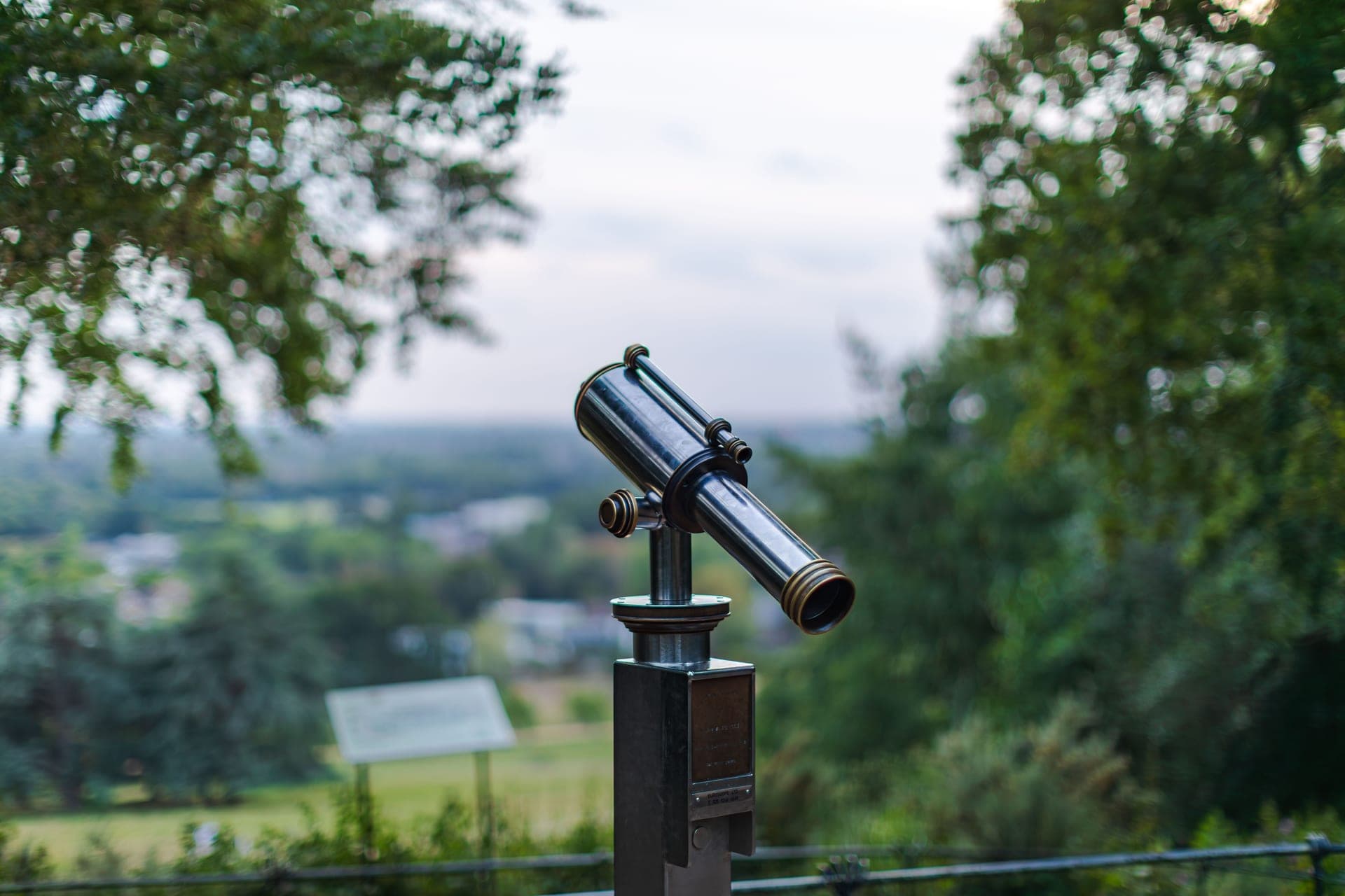 A telescope silhouetted against a bright sky