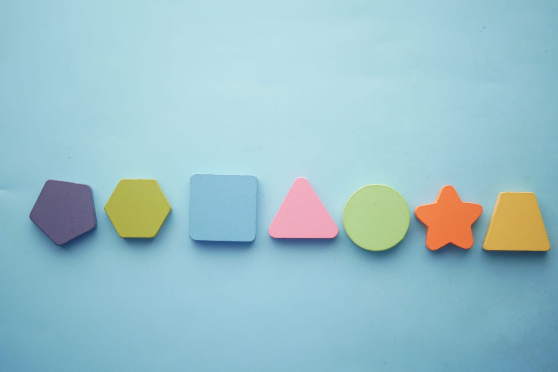 Children sorting colorful shapes and number tiles