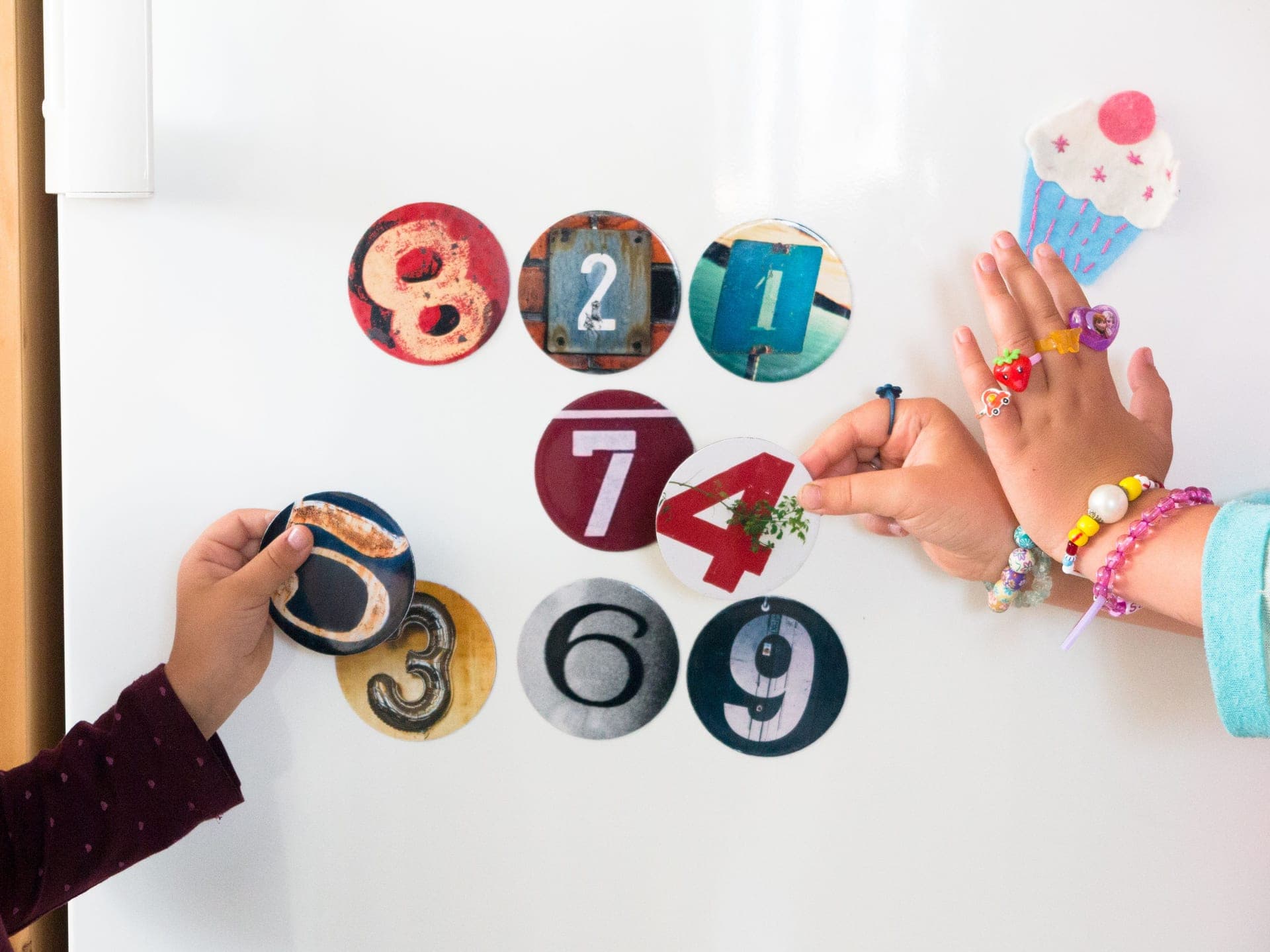 A child stacking colorful magnetic tiles