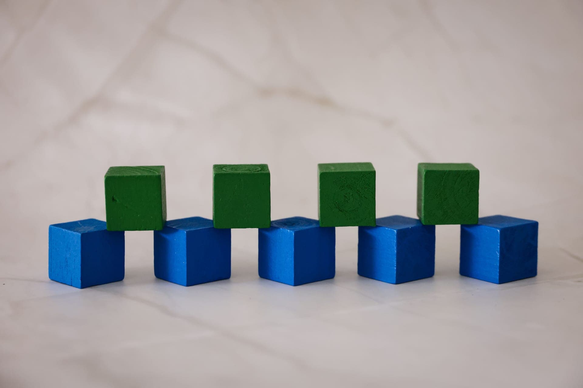 A wooden marble run built from colored blocks