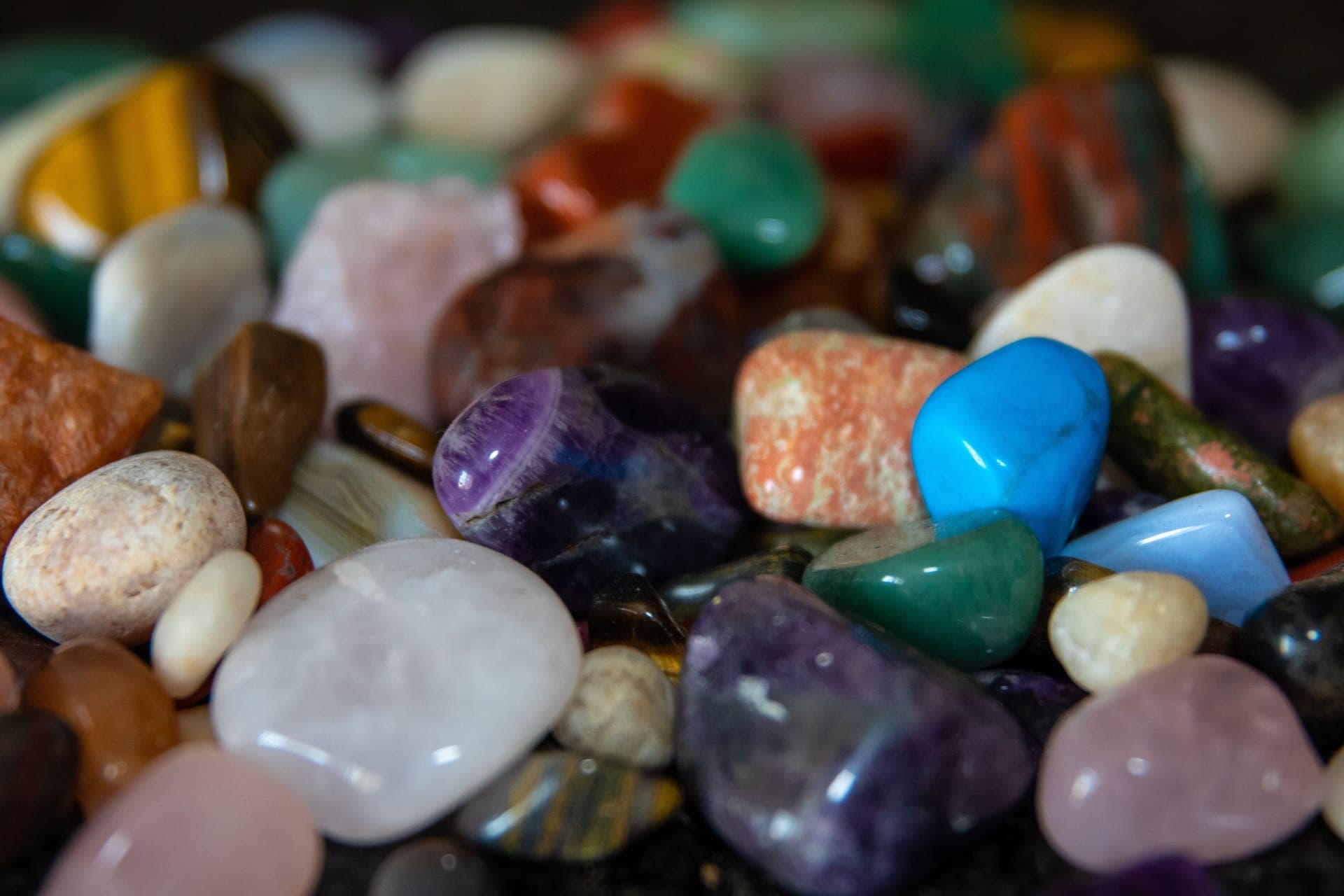 Polished colored gemstones in a pile