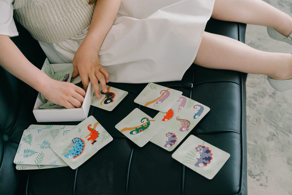 A young child arranging picture cards in a sequence