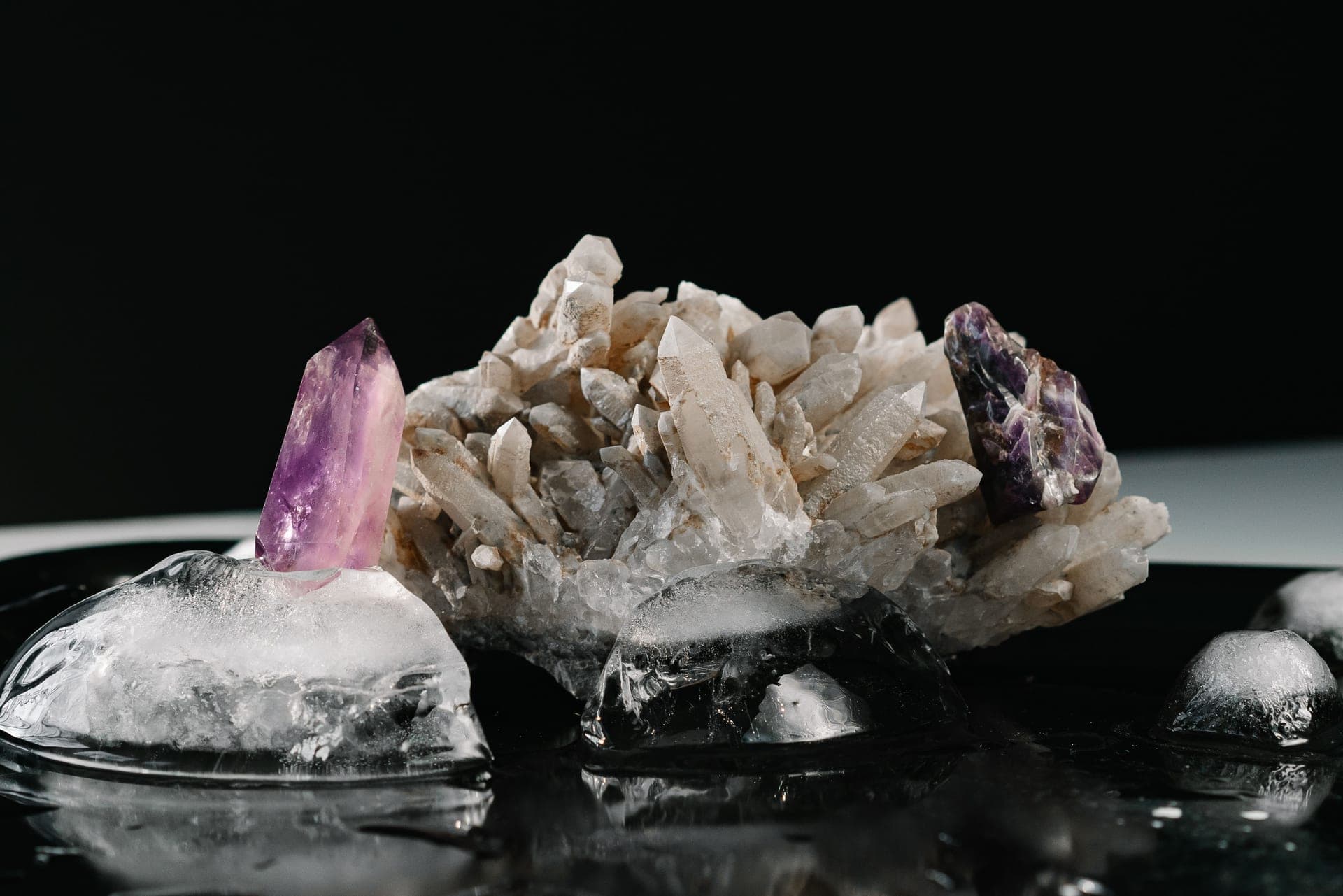 Colorful grown crystals arranged on a dark surface