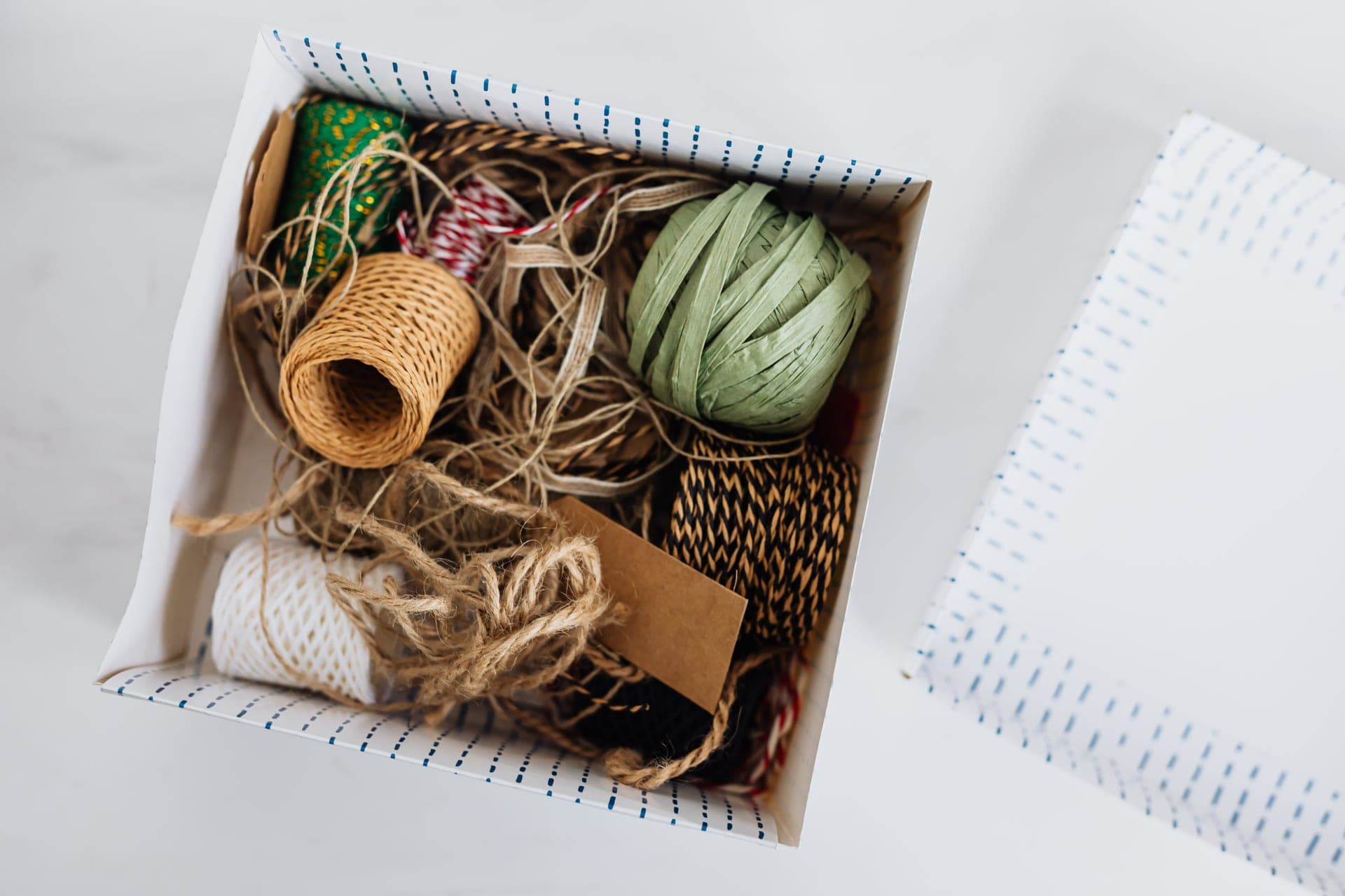 A cardboard project box with craft materials