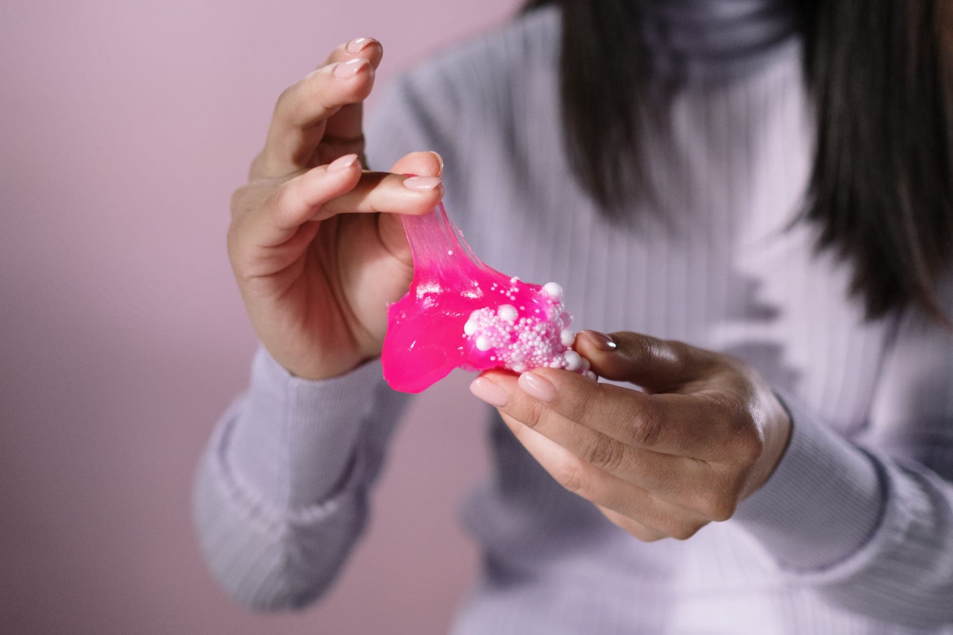 Colorful stretchy slime being pulled apart