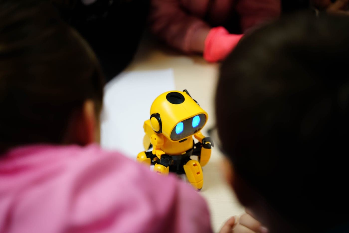 A small educational robot toy being used by a child